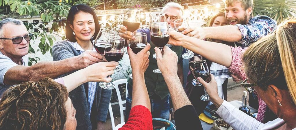 Happy family cheering with red wine